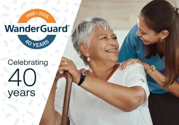 Senior living resident wearing WanderGuard BLUE bracelet is greeted by a community caregiver. Securitas Healthcare