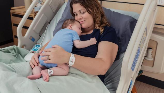Baby and Mom utilizing the Kisses and Hugs infant protection - Securitas Healthcare.
